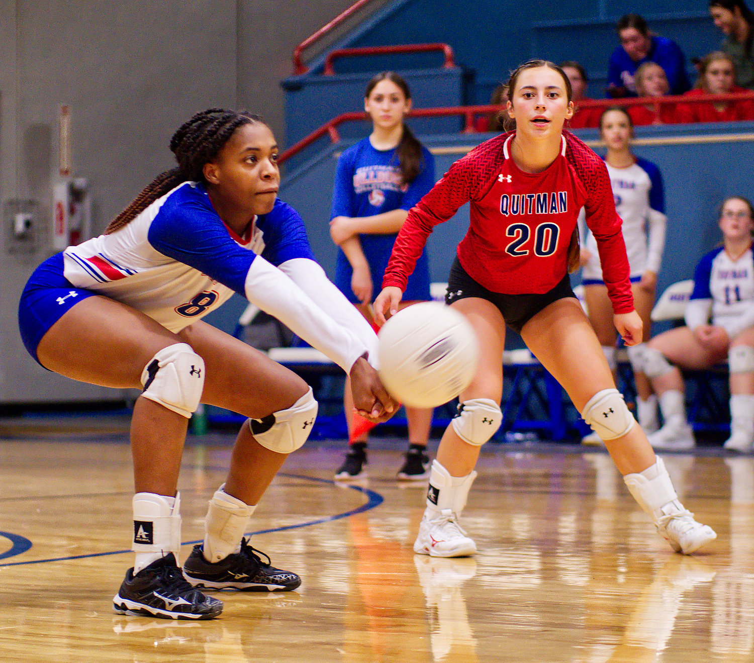 Newcomer of the year, sophomore Allie Berry, handles a dig as first-team all-district teammate Addison Marcee awaits, Aug. 23 at home vs. Quinlan-Boles. [view more shots from the volleyball season]